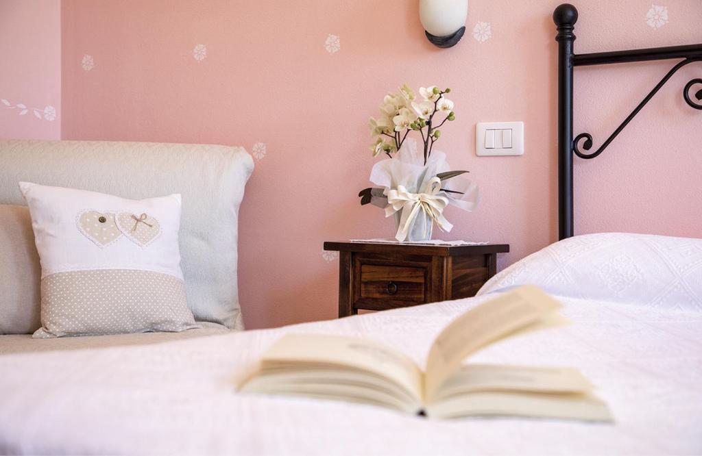 Postel nebo postele na pokoji v ubytování Agriturismo I Tre Fossi