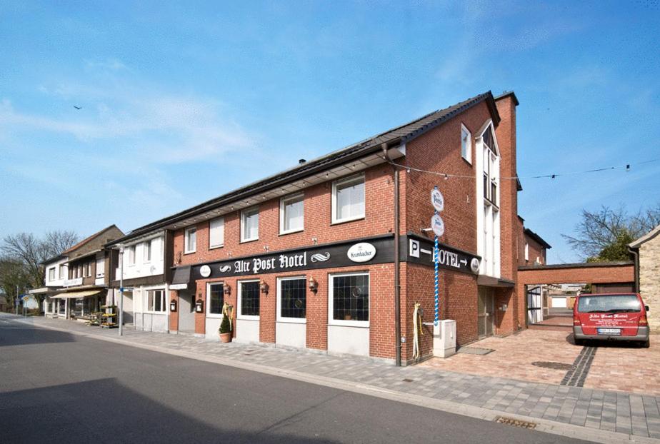 a large brick building with a sign on the front of it at Alte - Post - Hotel in Schöppingen