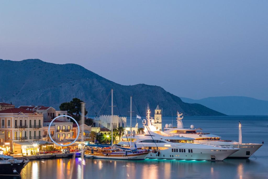 a group of boats docked in a harbor at night at Limani Life in Symi