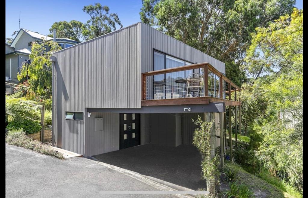 a modern house with a balcony and a deck at Bay Views Lorne in Lorne