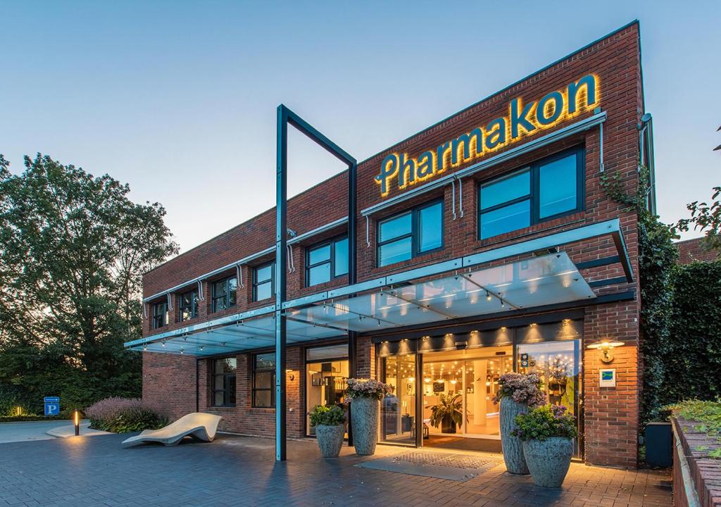 a brick building with a sign that reads phantasyolisolis at Pharmakon Hotel & Conferencecenter in Hillerød