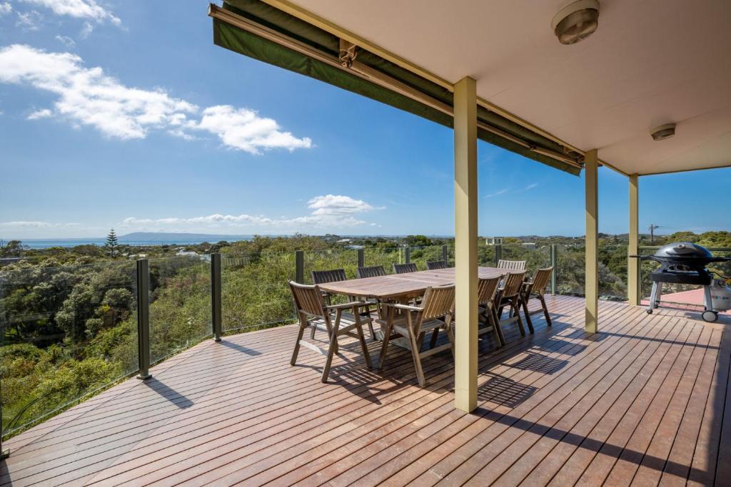 a deck with a table and chairs and a grill at The Views: Entertainers' deck and bay views in Sorrento