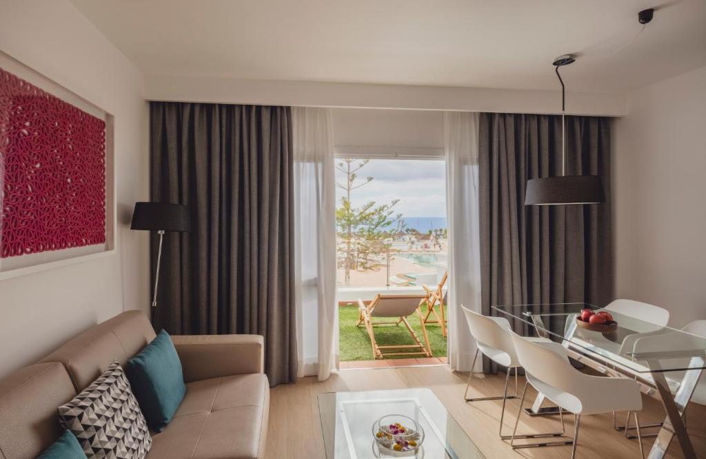 a living room with a couch and a glass table at Flamingo Beach Mate in Adeje