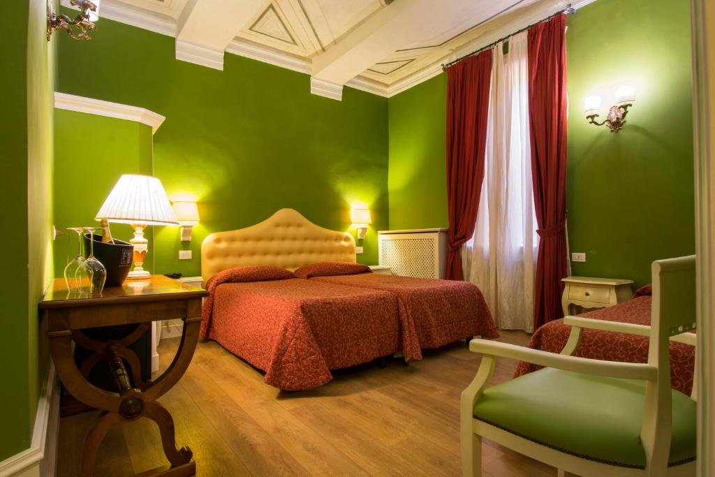 Postel nebo postele na pokoji v ubytování Hotel Pedrini