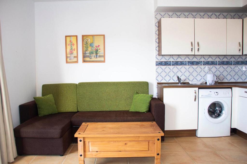 a living room with a couch and a washing machine at TAO El Cotillo in El Cotillo