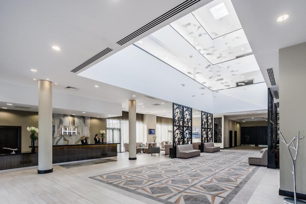 a lobby with couches and a reception area at Heston Hyde Hotel in Hounslow