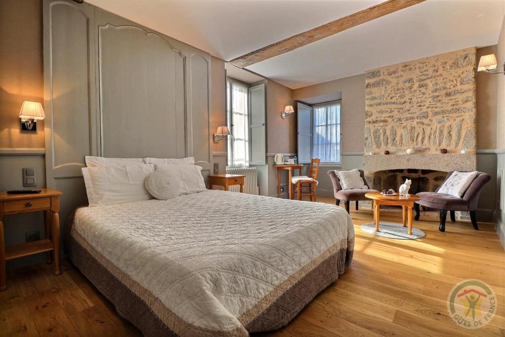 a bedroom with a bed and a living room at Gentilhommière de la Grande Toutenais in Saint Malo