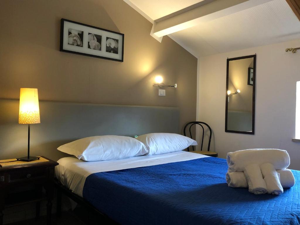 Postel nebo postele na pokoji v ubytování Hotel Casale dei Massimi