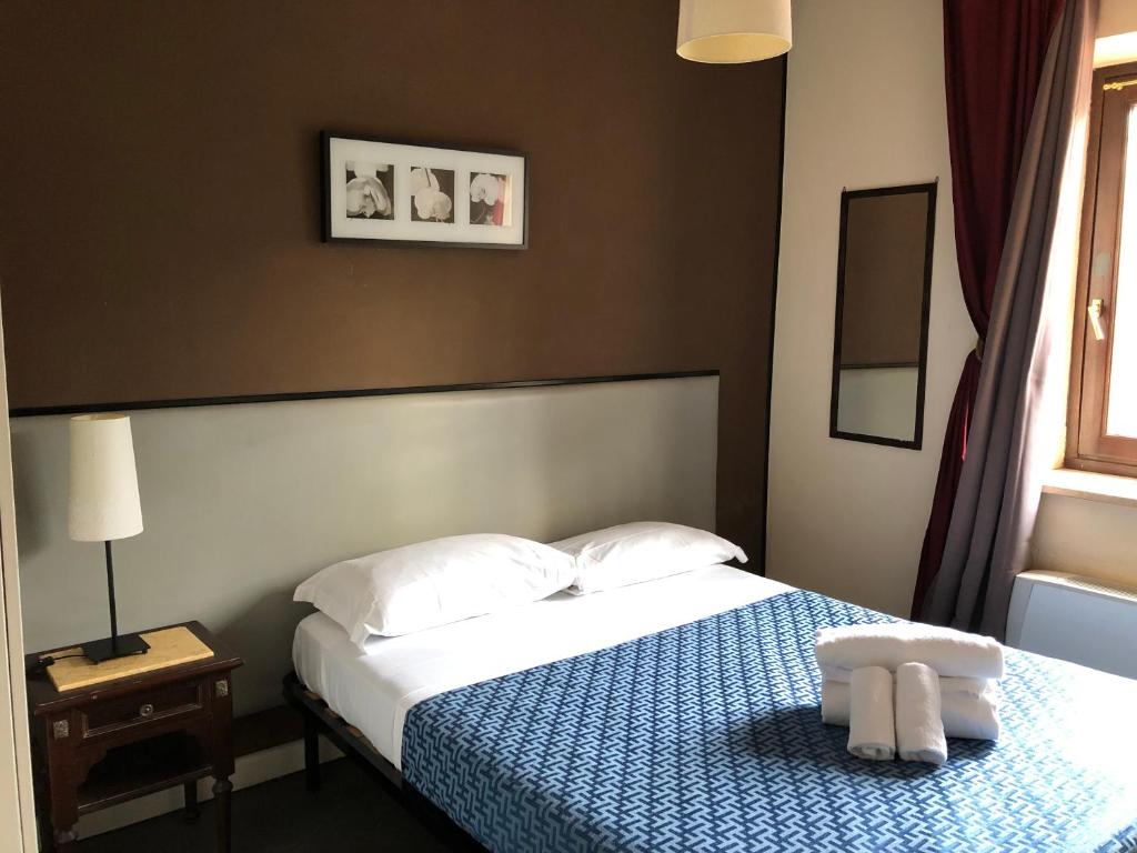 Postel nebo postele na pokoji v ubytování Hotel Casale dei Massimi
