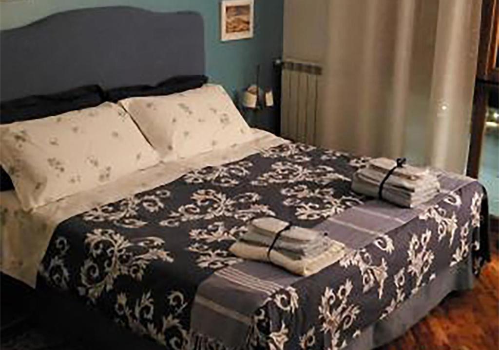 a bed with a black and white blanket and pillows at Baronessa B&B Florence in Florence