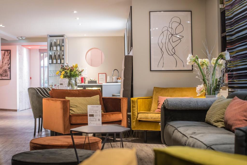 a living room with couches and chairs at Hôtel Couvent du Franciscain Centre ville in Strasbourg