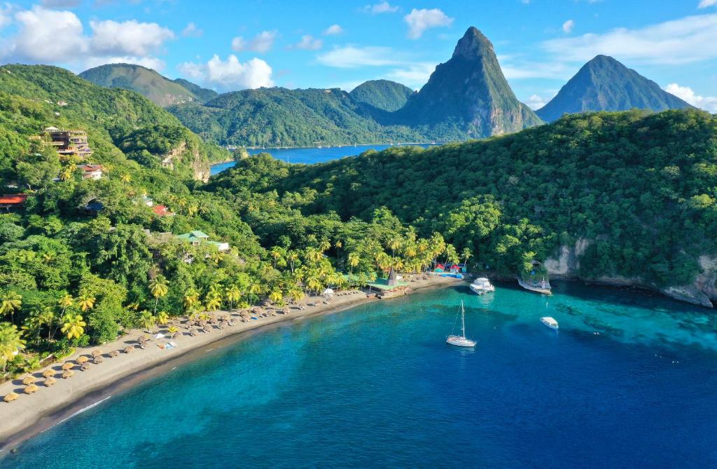 an aerial view of a beach with a boat in the water at Jade Mountain in Soufrière