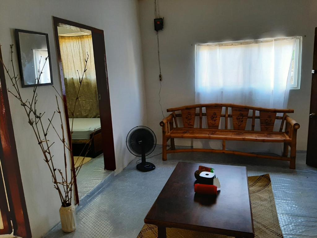 a living room with a couch and a table at Kalinaw Stay and Café in El Nido