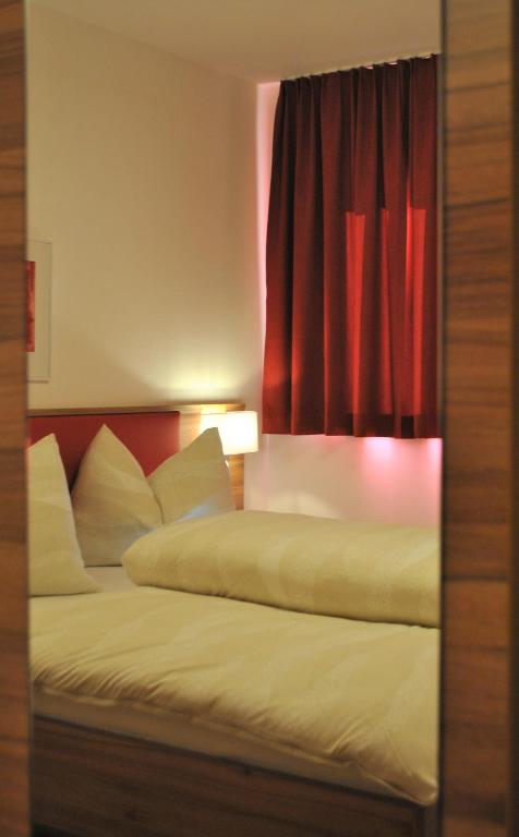 Postel nebo postele na pokoji v ubytování Hotel Mauernböck