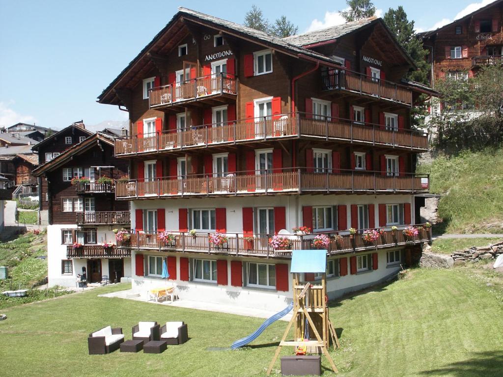 a large building with balconies on the side of it at Anemone in Saas-Fee