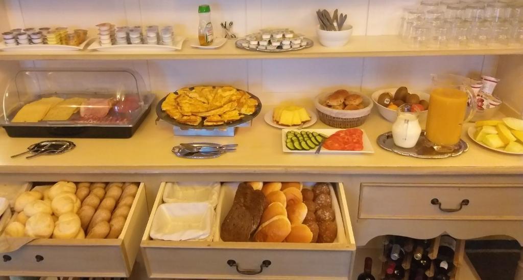 a cabinet filled with lots of different types of food at Auberge 's Gravenhof in Voeren