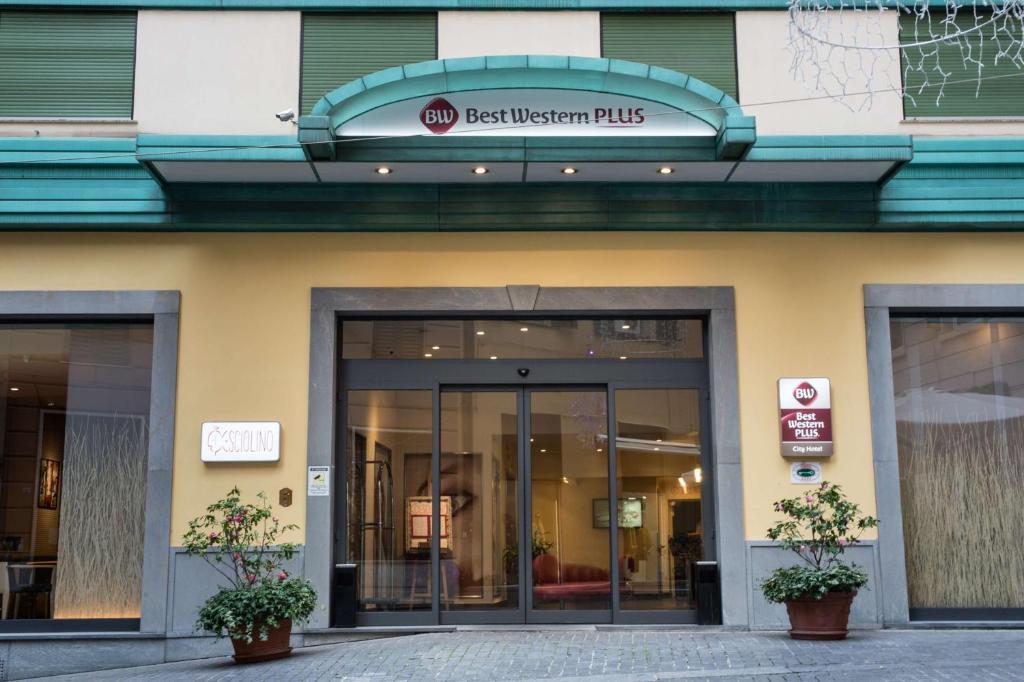 a building with the entrance to the best western plus at Best Western Plus City Hotel in Genoa