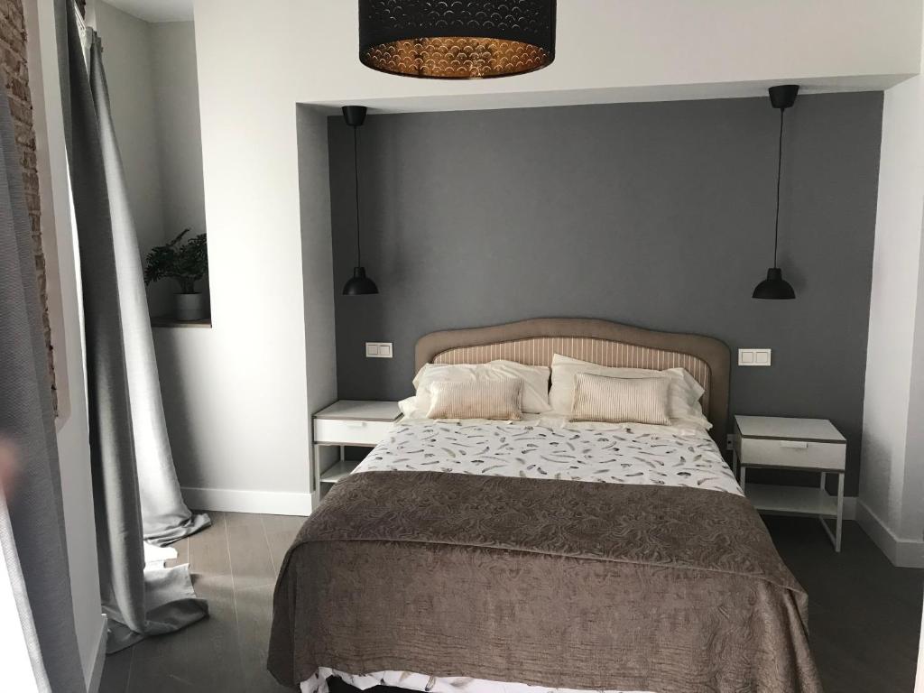 A bed or beds in a room at Apartamentos DUKE