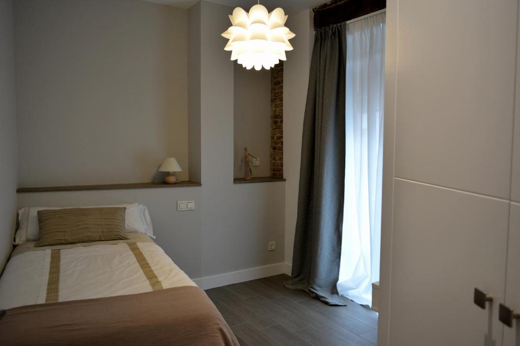 A bed or beds in a room at Apartamentos DUKE