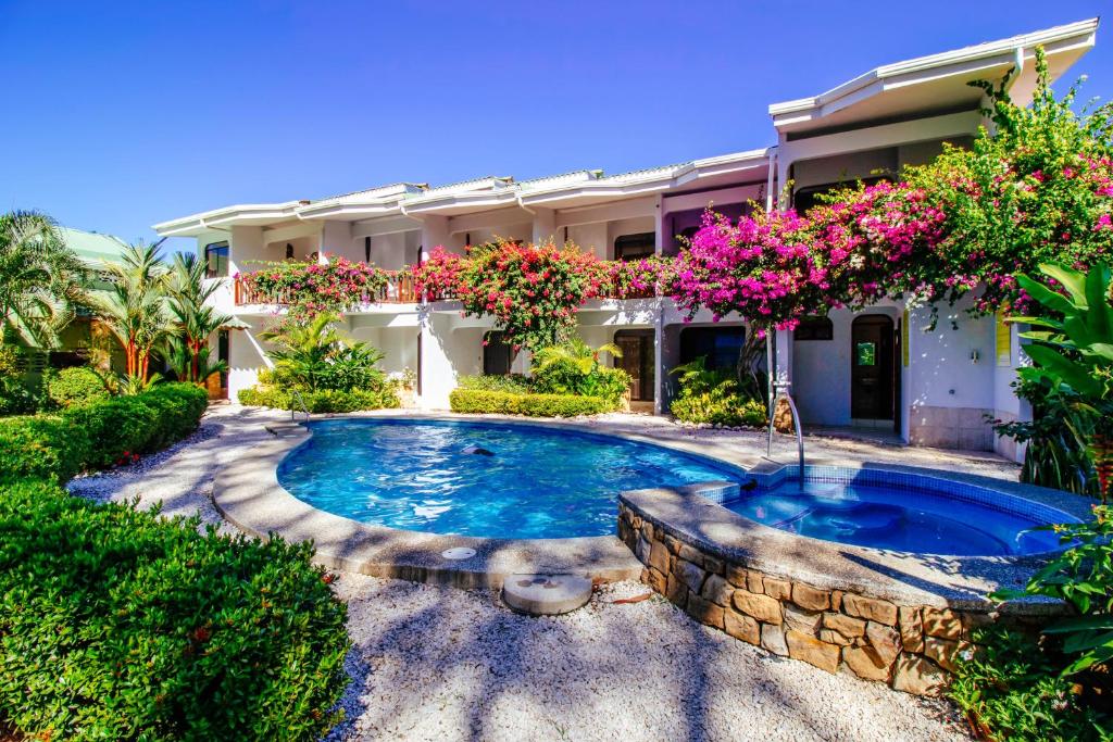 a swimming pool in front of a house at Hotel Giada in Sámara