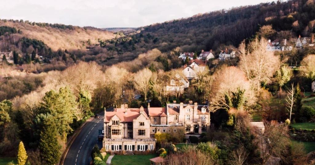 an aerial view of a large house in the hills at The Maynard in Grindleford Bridge