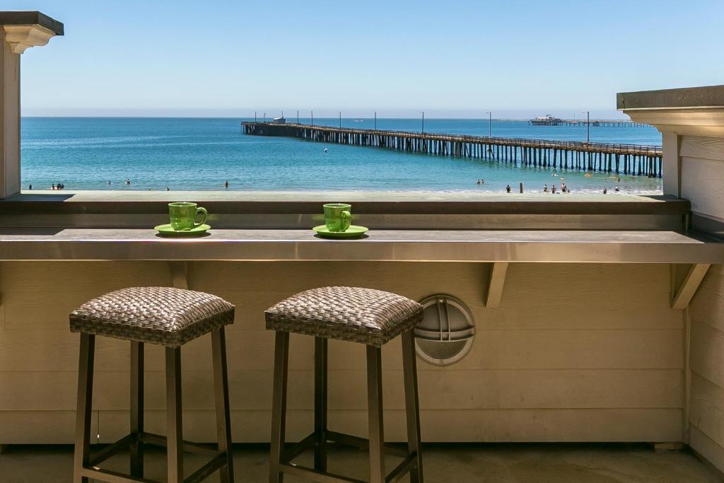a bar with two chairs and a view of the beach at 358 Front Street in Avila Beach