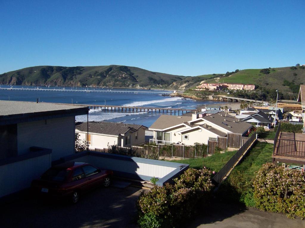 a house with a car parked next to a body of water at 141 A 1st Street in Avila Beach