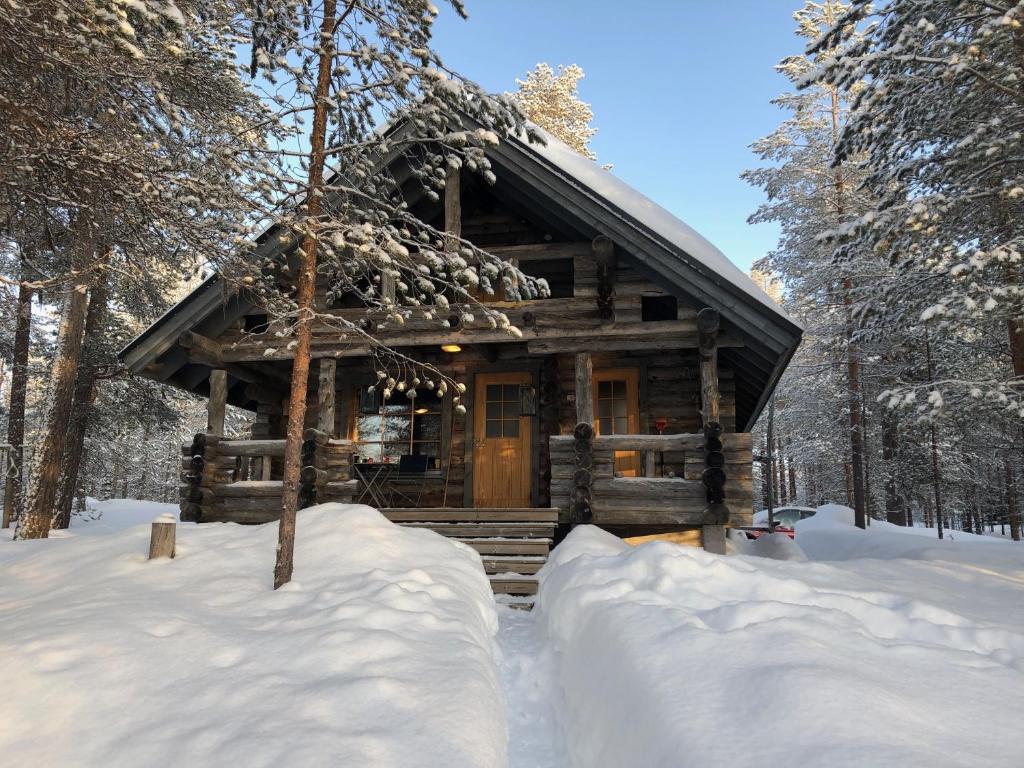 een blokhut in het bos in de sneeuw bij Villa Kelotupa in Hossa