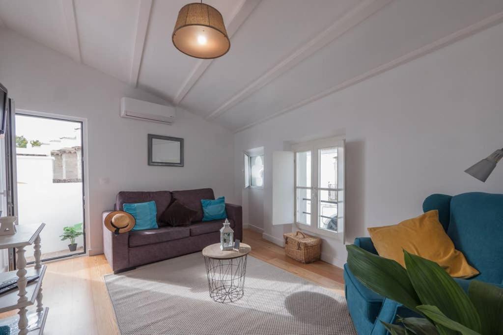 a living room with a couch and a table at Home in one of Évora´s most historical squares in Évora