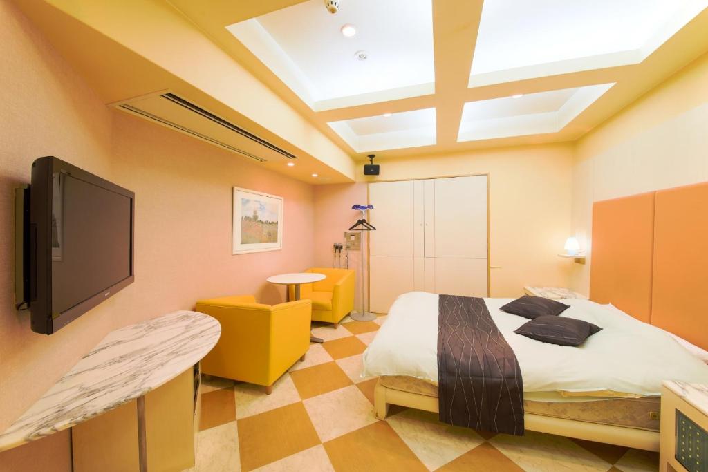 a bedroom with a bed and a flat screen tv at Osaka - Hotel / Vacation STAY 70127 in Osaka