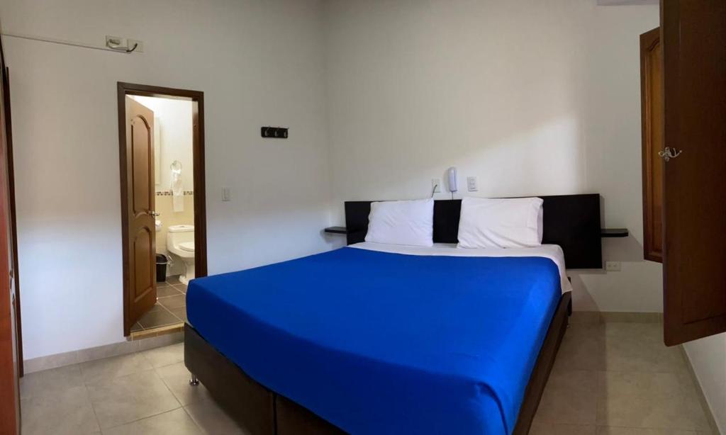 Säng eller sängar i ett rum på Hotel Abadias De Zapatoca