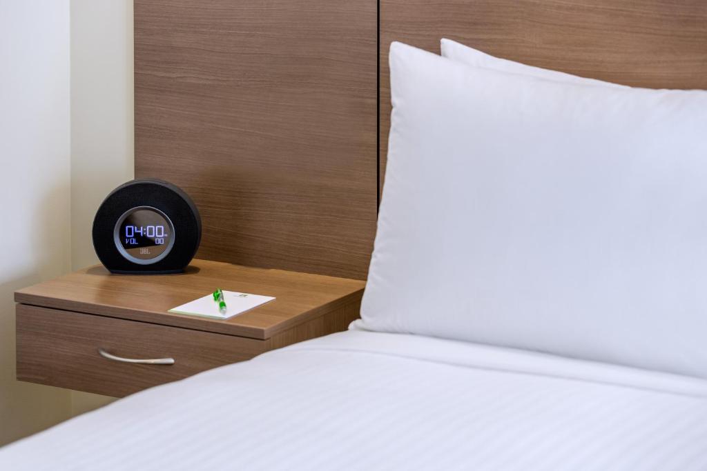 מיטה או מיטות בחדר ב-Holiday Inn Auckland Airport, an IHG Hotel