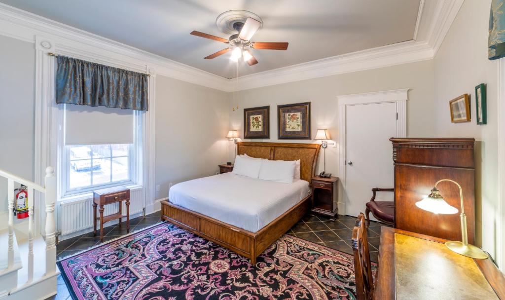a bedroom with a bed and a ceiling fan at Chipman Hill Suites - Union Street in Saint John
