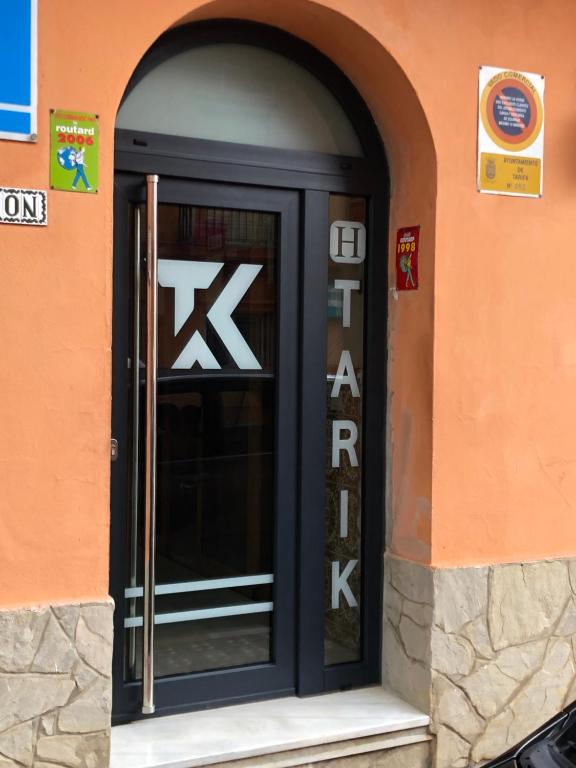 una puerta negra de un edificio con la palabra "kichen" en Hostal Tarik, en Tarifa