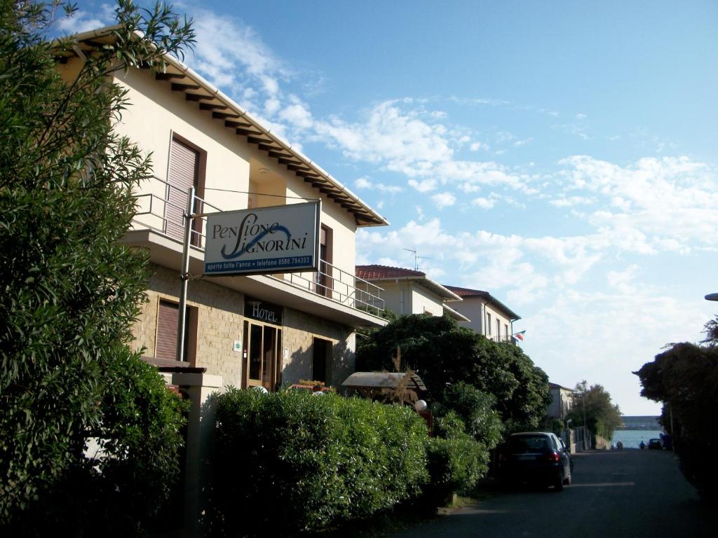 a building with a sign on the side of it at Hotel Pensione Signorini in Castiglioncello