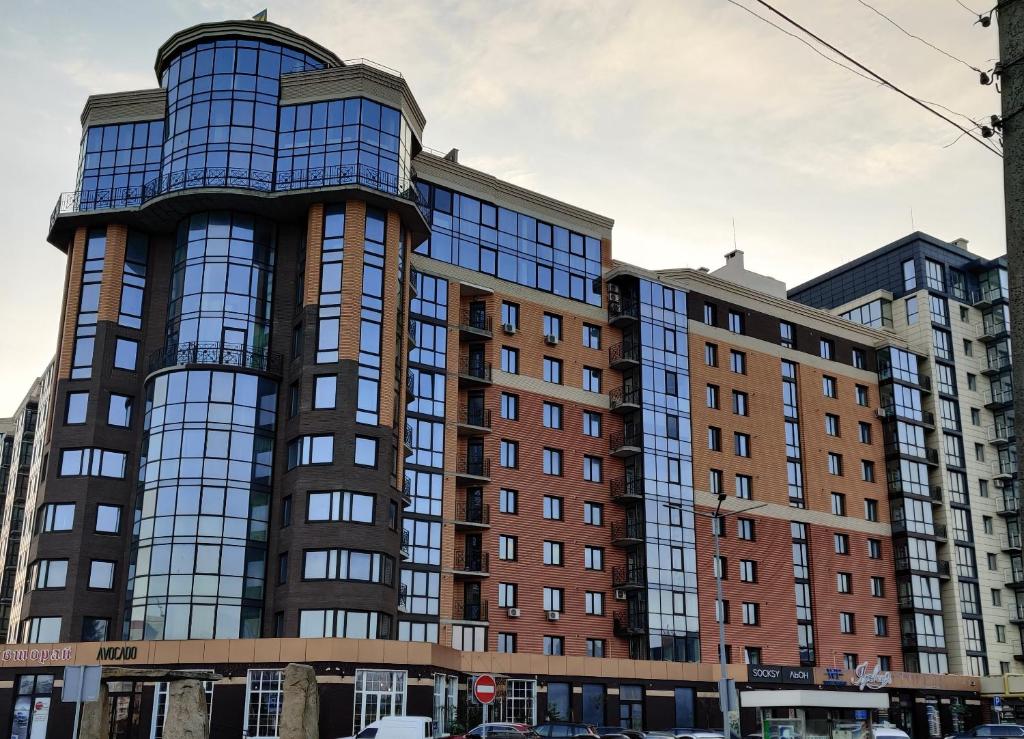 a tall building with many windows on a city street at Yarovytsya VIP in the CENTER in Luts'k