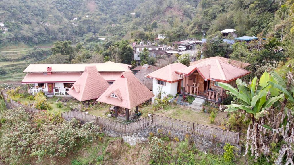 a group of houses on a hill in a village at Baleh Boble Guesthouse in Banaue