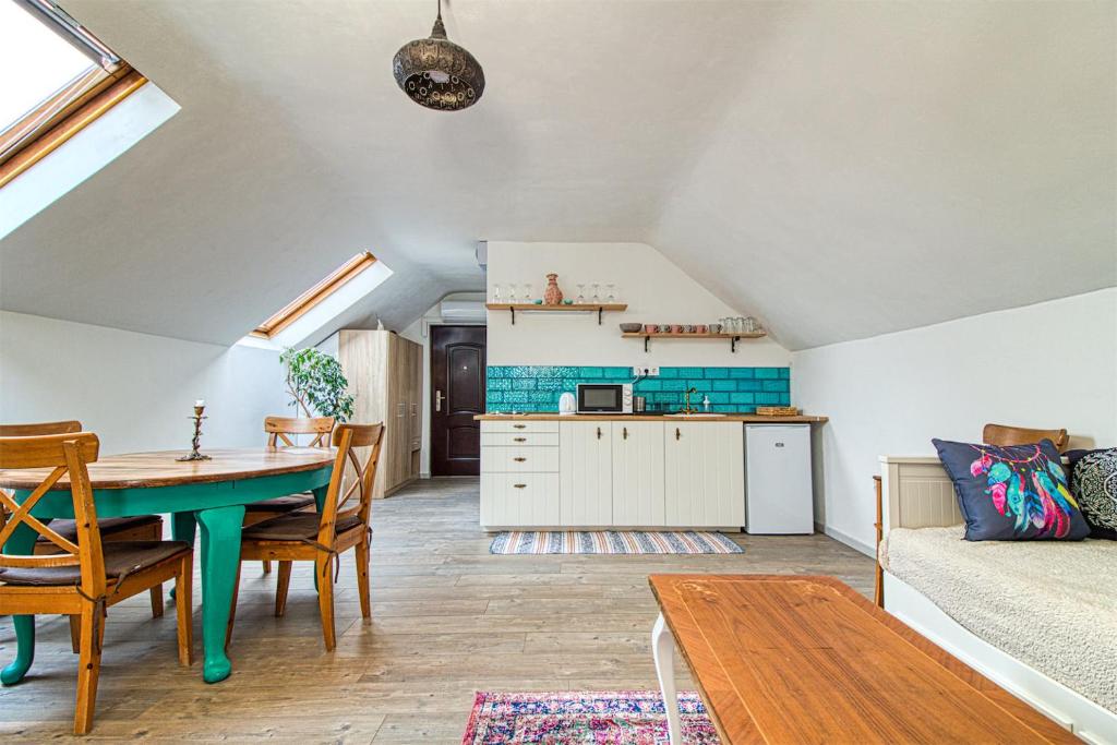kuchnia i jadalnia z zielonym stołem w pokoju w obiekcie Boholand Apartman Eger w Egerze