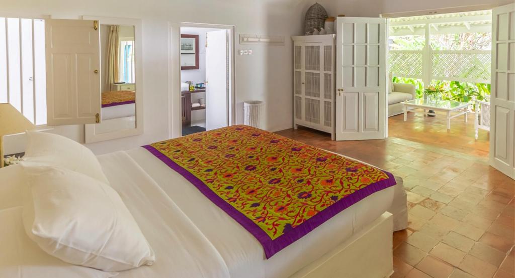a bedroom with a bed and a living room at Nyne Hotels Rock Villa, Bentota in Bentota