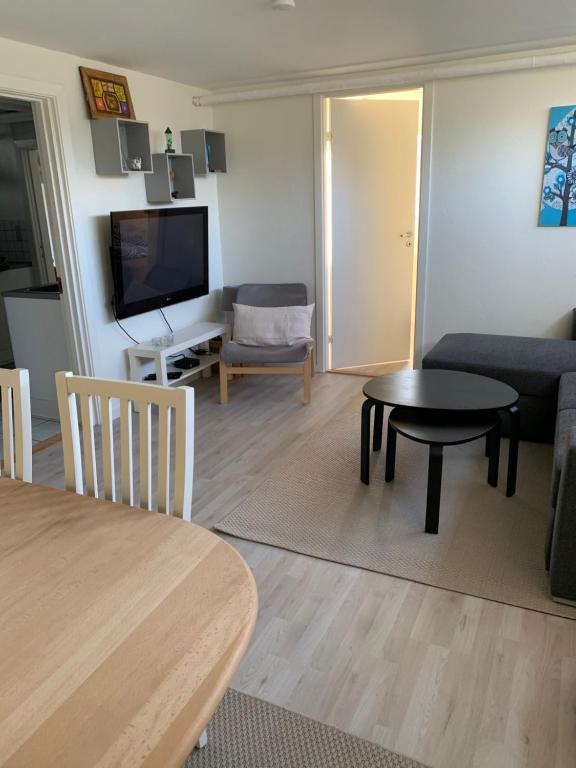 a living room with a couch and a table at Surf Apartment Stormgade in Hvide Sande