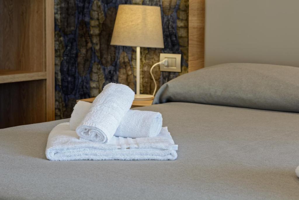 Postel nebo postele na pokoji v ubytování Hotel Serenella