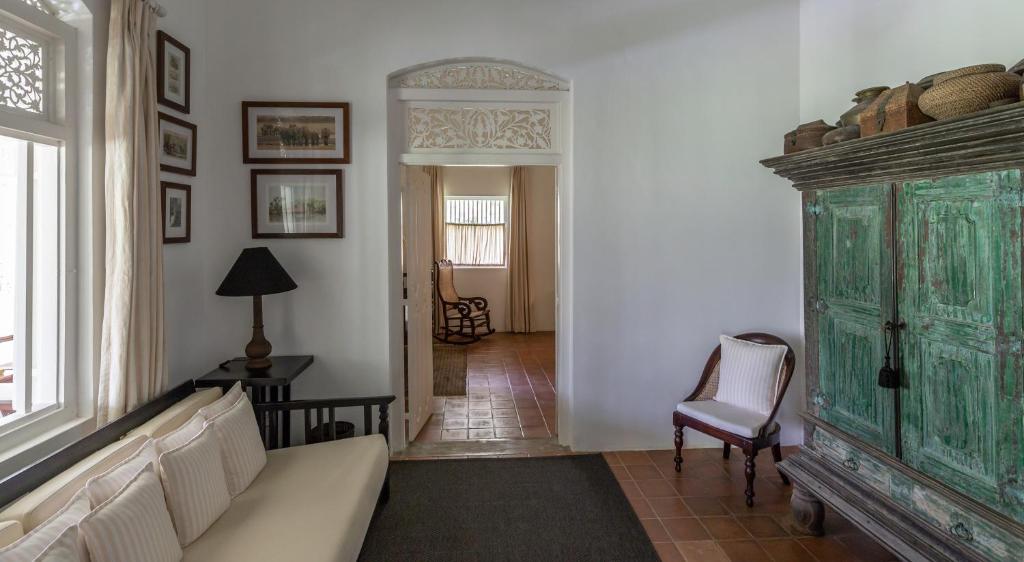 a living room with a couch and a green cabinet at Nyne Hotels Rock Villa, Bentota in Bentota