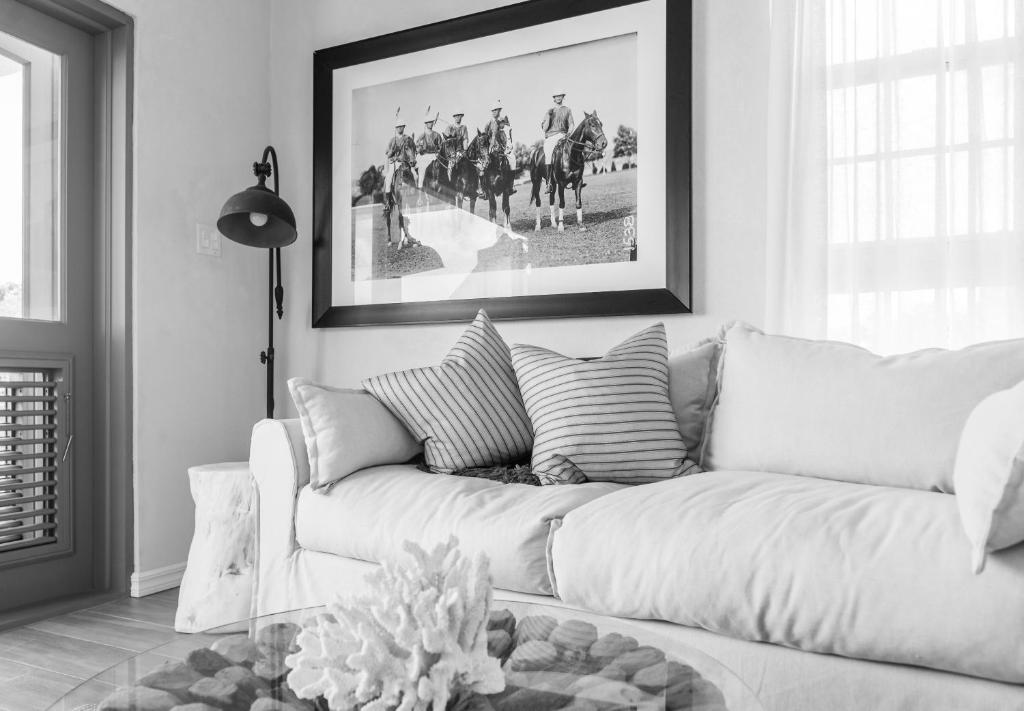 a living room with a white couch and a picture at West Rock Villas in Saint James