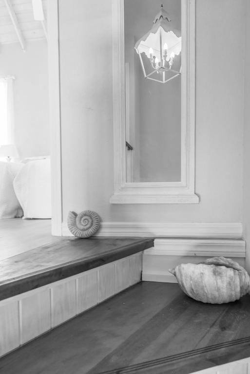 a room with a bench with a large mirror and a mirror at West Rock Villas in Saint James