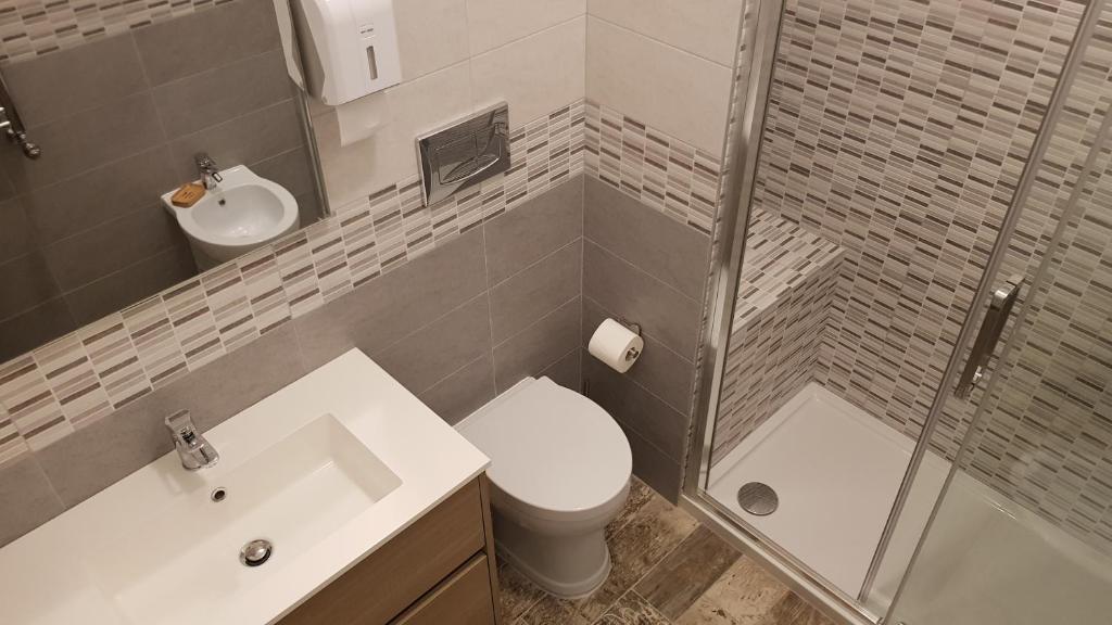 a bathroom with a toilet and a sink and a shower at THAT'S AMORE FIUMICINO Airport in Fiumicino