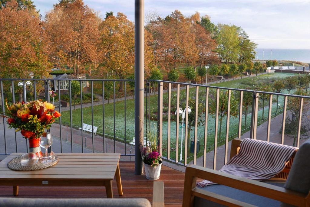 a balcony with a table and a view of the water at Baabe Villen Ensemble FeWo 12 Meer in Baabe