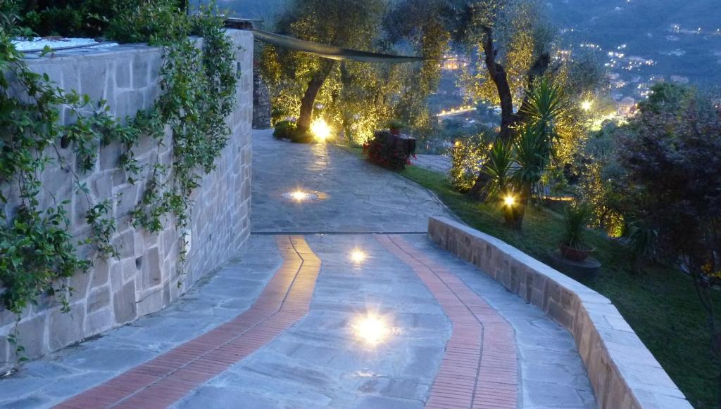 an outdoor pathway with lights at night at la gatta sul sentiero in San Salvatore