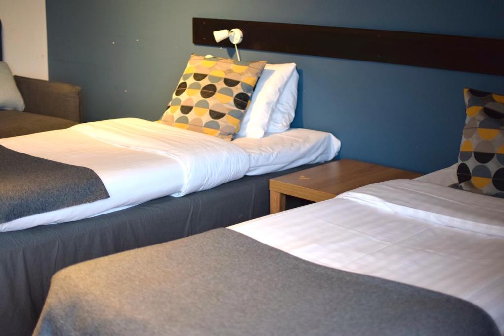 Postel nebo postele na pokoji v ubytování Vätterleden Hotell & Restaurang