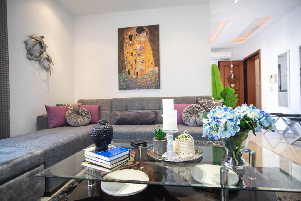 a living room with a couch and a glass table at Luxury & Cozy Apartment in Volos