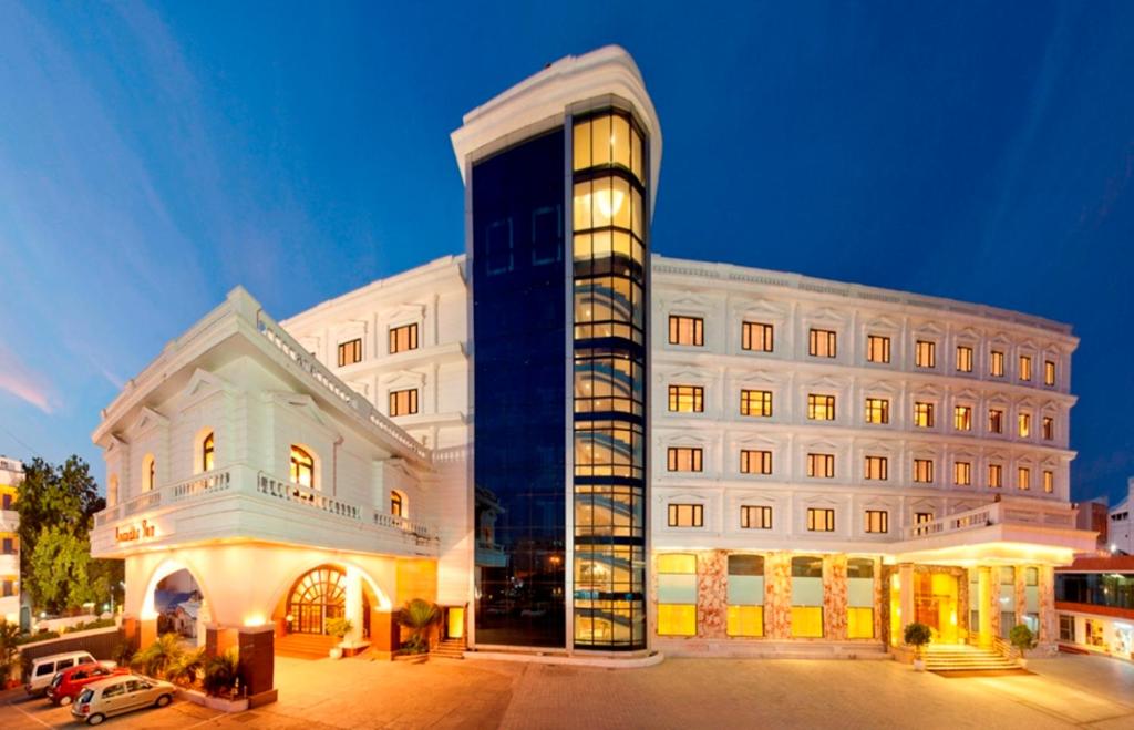 a large white building with a building at Anandha Inn Convention Centre and Suites in Pondicherry